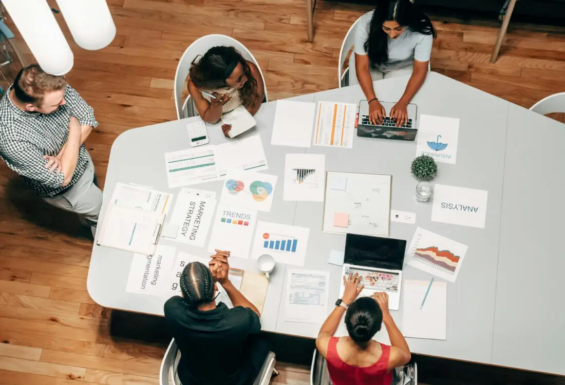 A group of people discussing fractional CMO services
