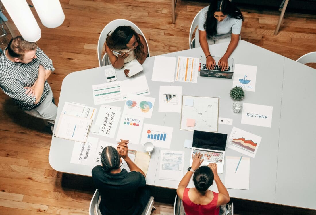 A group of people discussing fractional CMO services